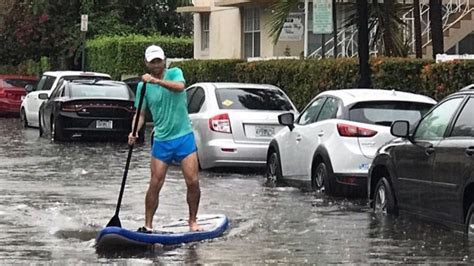 Person paddle boarding through flood
